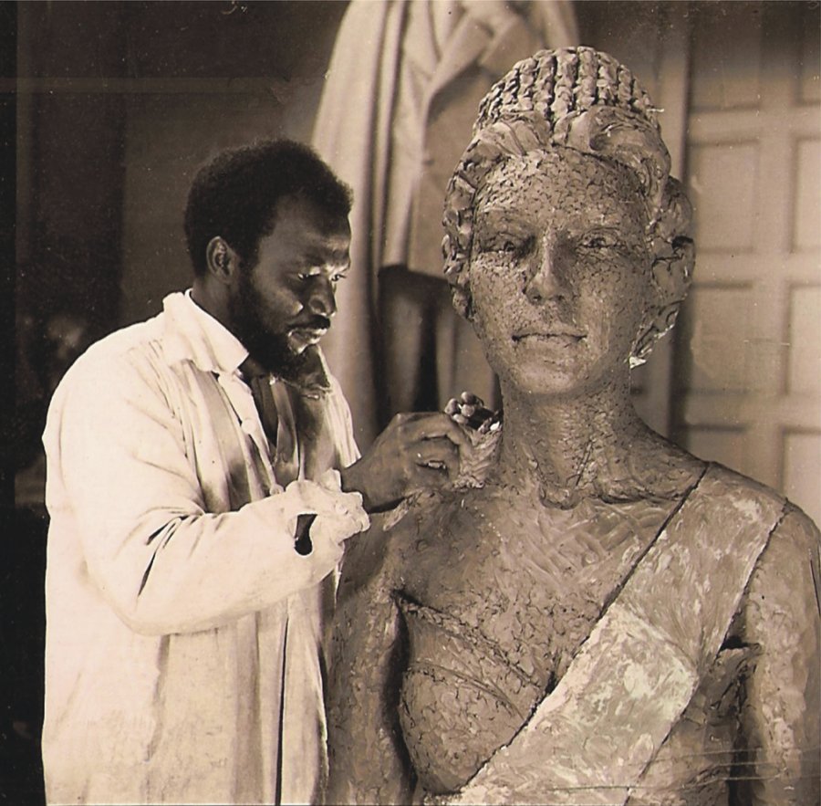 Ben Enwonwu working on a bronze sculpture of Queen Elizabeth II in the studio of Sir William Reid-Dick. Courtesy The Ben Enwonwu Foundation.jpg